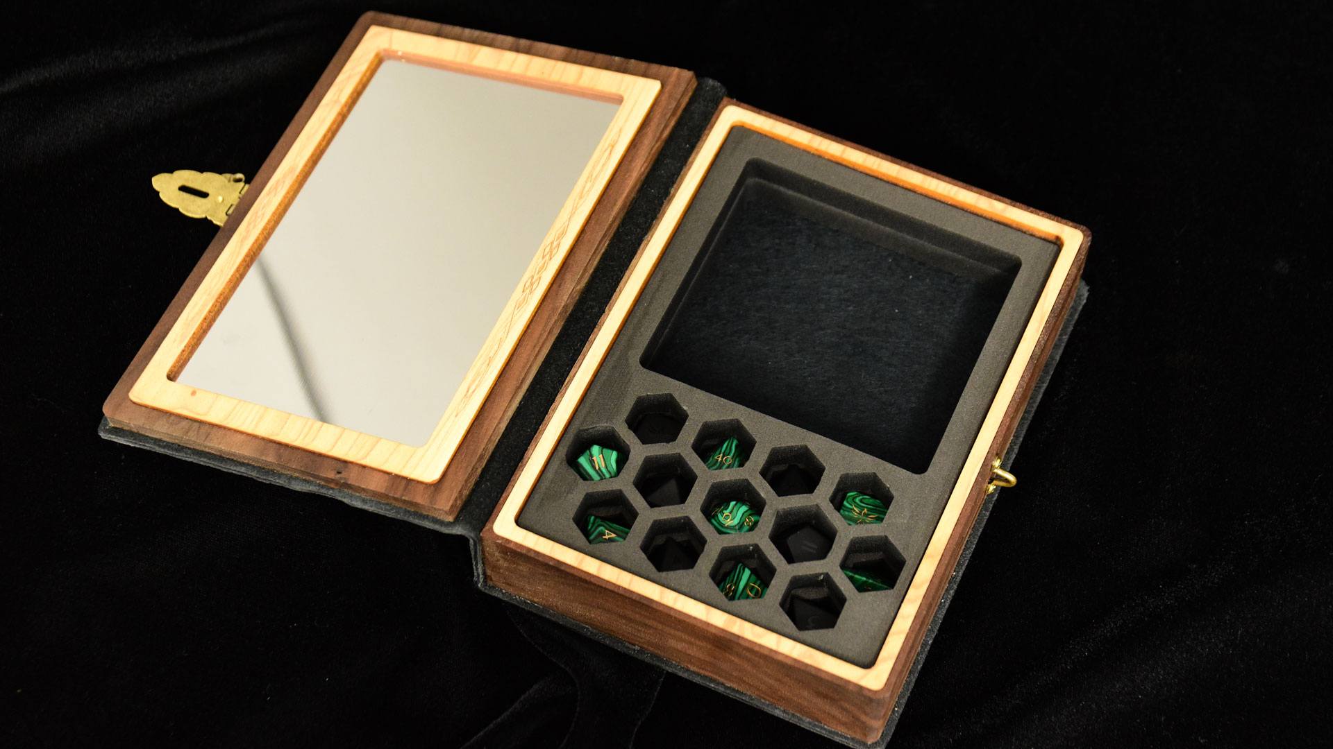 Interior of Cthulhu Spellbook gaming box with foam insert holding gemstone dice