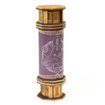 Purple leather codex dice tower with engraved maple and walnut caps against a white background