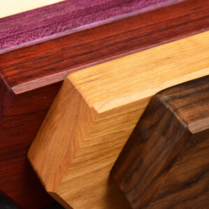 Maple, purpleheart, padauk, cherry, and walnut woods, handcrafted and wax-finished into rupee style double hex-chest dice boxes